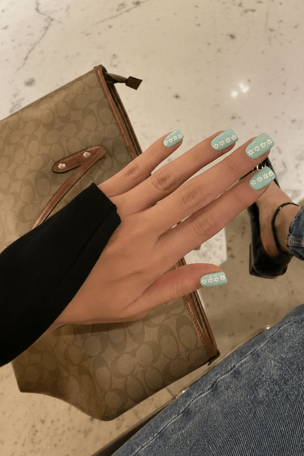 Short square nails in pale turquoise with white daisy chain art