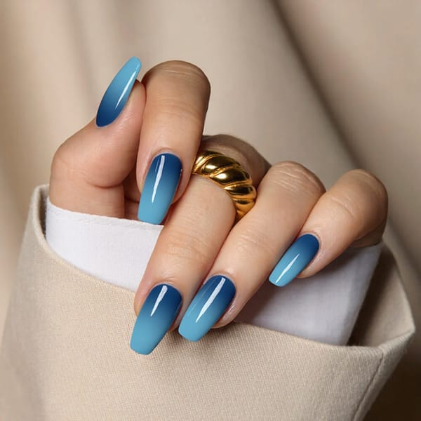Medium square nails in an icy blue ombre, fading from light to dark for a cool January aesthetic.