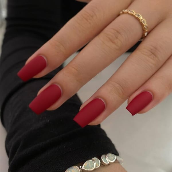 Short stiletto nails in matte red with a glossy French tip
