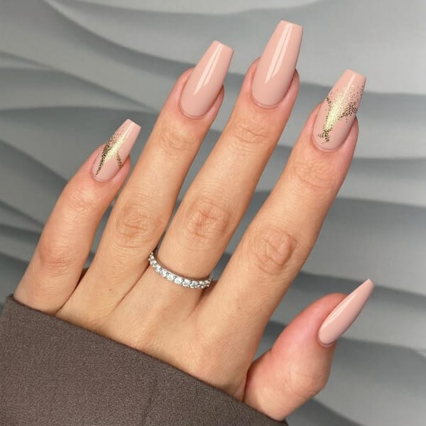 Long almond nails in a baby pink with gold foil accents near the cuticles for a fresh spring shine.