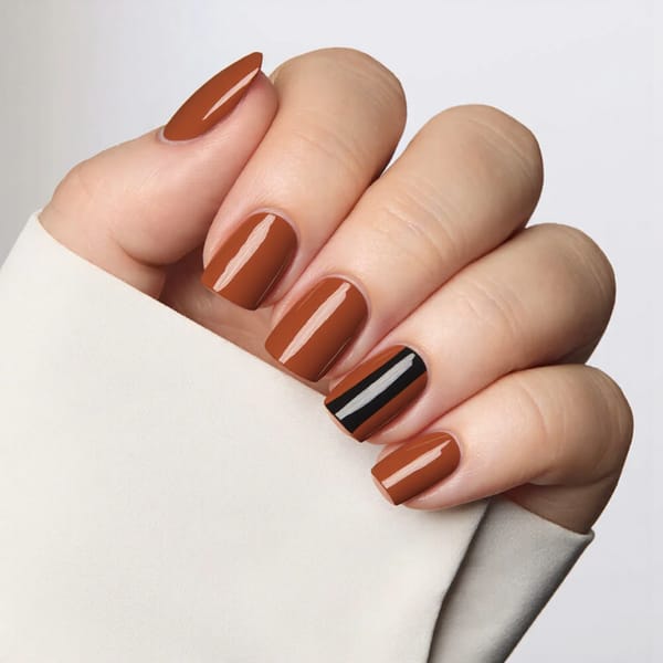 I'd like short square nails in a warm copper shade with a diagonal black stripe for a bold autumn statement.