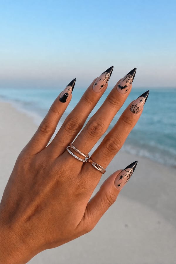 Haloween nail Nail shape: stiletto. Nail length: long. Only change the nails visible in the image to match this design. Keep the rest of the image — the hand, skin, background, lighting, and everything else — exactly the same.