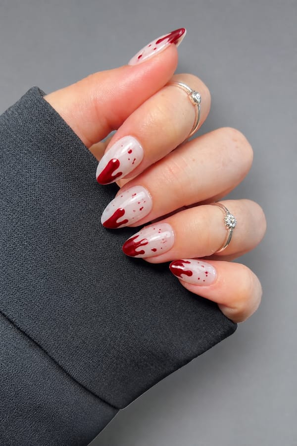 horro nail Nail shape: almond. Nail length: medium. Only change the nails visible in the image to match this design. Keep the rest of the image — the hand, skin, background, lighting, and everything else — exactly the same.