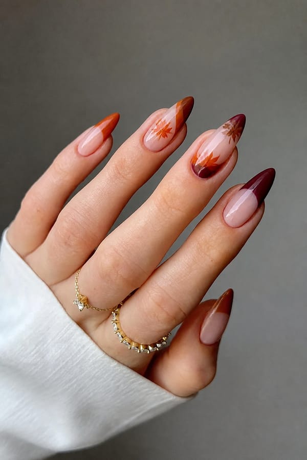 autumn theme Nail shape: stiletto. Nail length: medium. Only change the nails visible in the image to match this design. Keep the rest of the image — the hand, skin, background, lighting, and everything else — exactly the same.