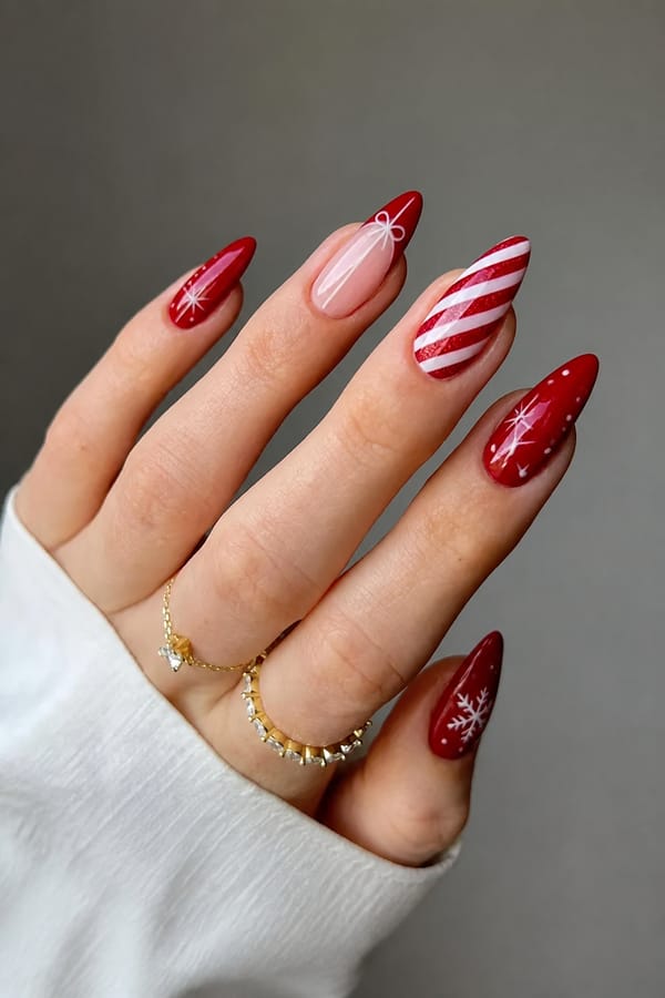 Christmas theme Nail shape: stiletto. Nail length: medium. Only change the nails visible in the image to match this design. Keep the rest of the image — the hand, skin, background, lighting, and everything else — exactly the same.