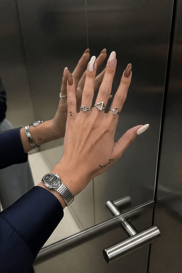 brown white pink and gold Nail shape: almond. Nail length: long. Only change the nails visible in the image to match this design. Keep the rest of the image — the hand, skin, background, lighting, and everything else — exactly the same.