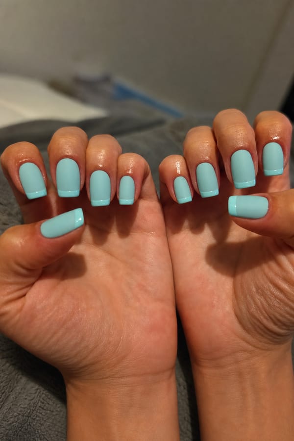 Tiffany blue solid matte with glossy French tip Nail shape: square. Nail length: medium. Only change the nails visible in the image to match this design. Keep the rest of the image — the hand, skin, background, lighting, and everything else — exactly the same.