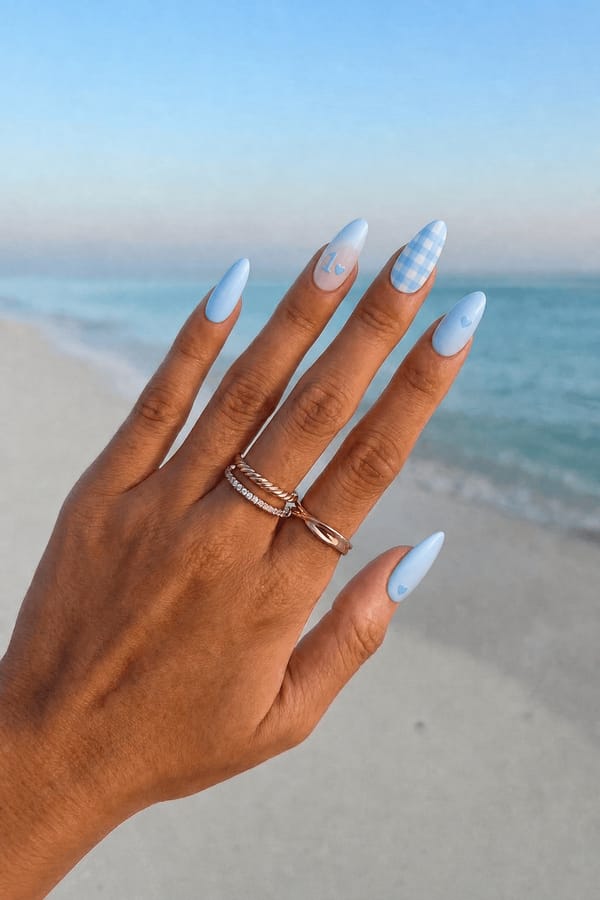 cute simple first birthday blue nails Nail shape: almond. Nail length: long. Only change the nails visible in the image to match this design. Keep the rest of the image — the hand, skin, background, lighting, and everything else — exactly the same.