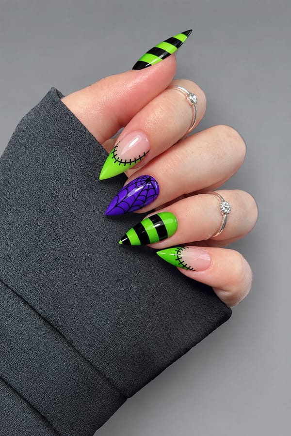 Full French tip nails set, with stitches. the colors used are electric purple , black and neon green.each nail a different design. one or two with green and black horizontal stripes another with green french tip and stitches around curve of French tip. one with a spiderweb. Nail shape: stiletto. Nail length: long. Only change the nails visible in the image to match this design. Keep the rest of the image — the hand, skin, background, lighting, and everything else — exactly the same.