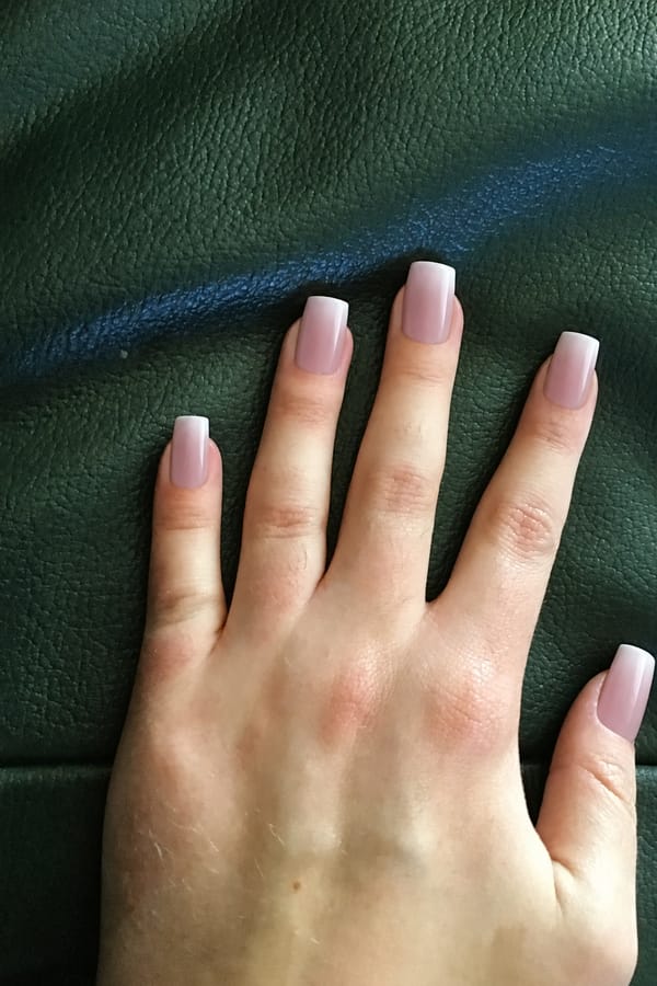 Dusty rose with subtle white ombre tips, perfect for any occasion Nail shape: square. Nail length: long. Only change the nails visible in the image to match this design. Keep the rest of the image — the hand, skin, background, lighting, and everything else — exactly the same.