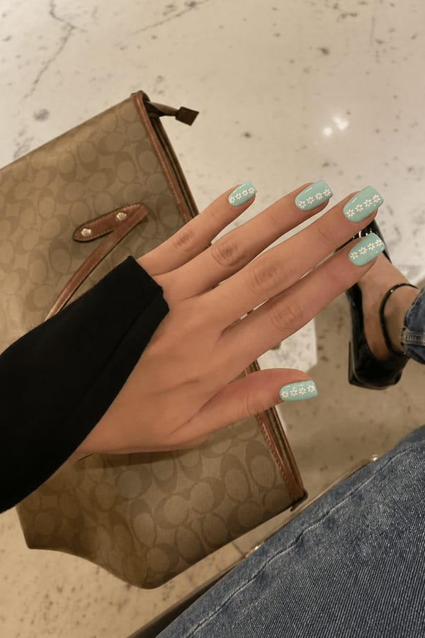 Pale turquoise with daisy chain designs and a glossy finish