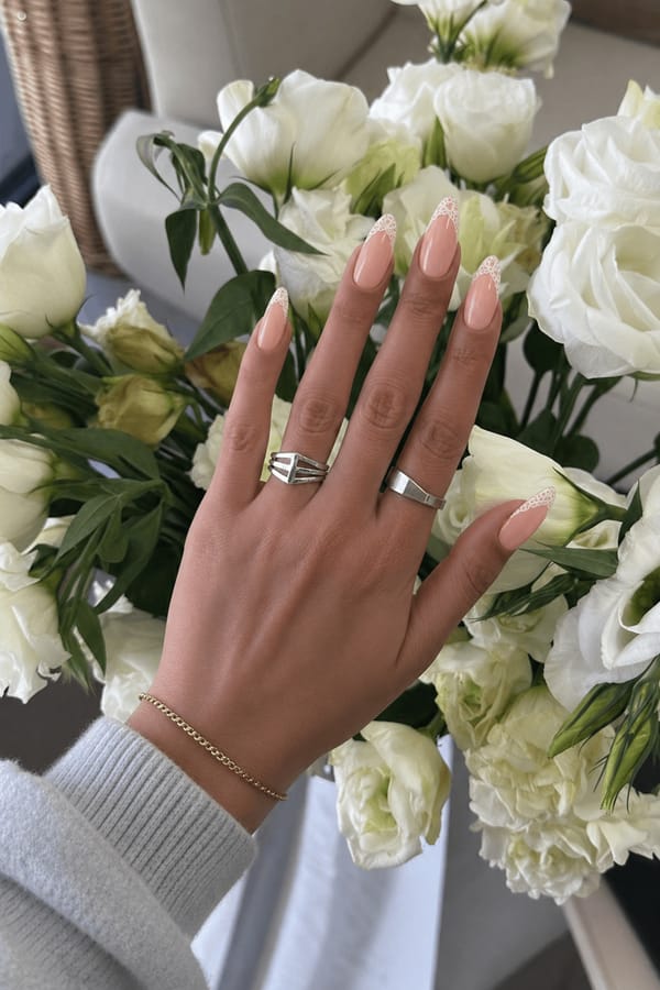 Pastel peach base adorned with delicate white lace French tips