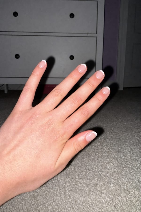 summer French Nail shape: almond. Nail length: short. Only change the nails visible in the image to match this design. Keep the rest of the image — the hand, skin, background, lighting, and everything else — exactly the same.