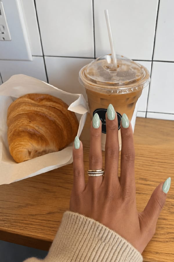 Mint green square tips with subtle white wave patterns