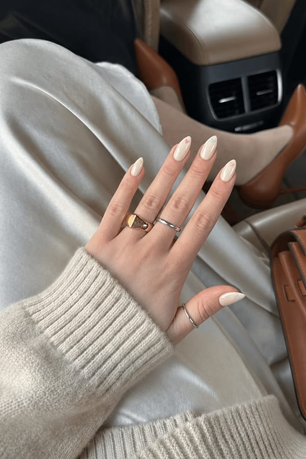 Creamy beige with mini pastel heart accents at the French tips