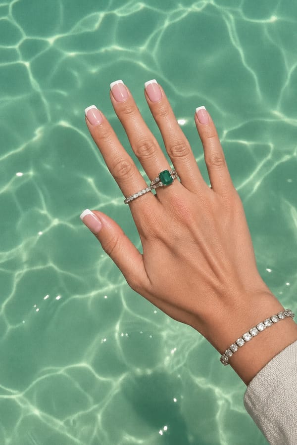 Classic white French tips on a soft pink base for an elegant touch