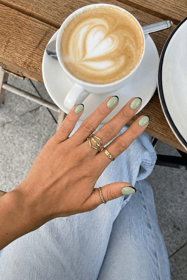Mint green with a chic black French tip for a modern twist