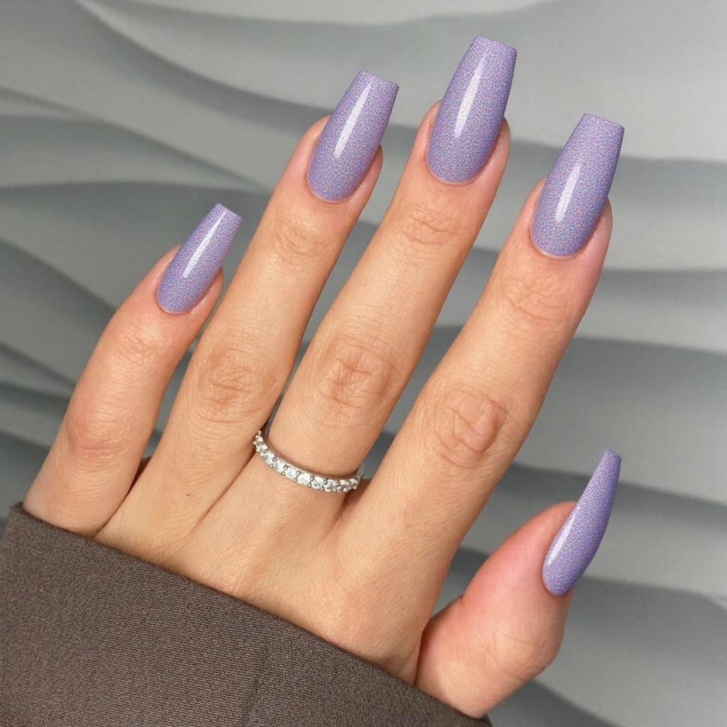Long almond nails in a holographic lavender shade that catches the light for a magical effect.