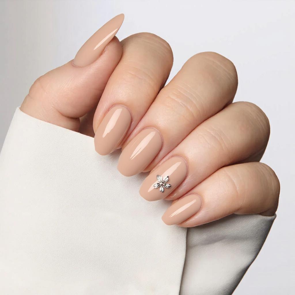 I'd love medium almond nails in a sheer nude with a tiny, delicate flower on each ring finger.