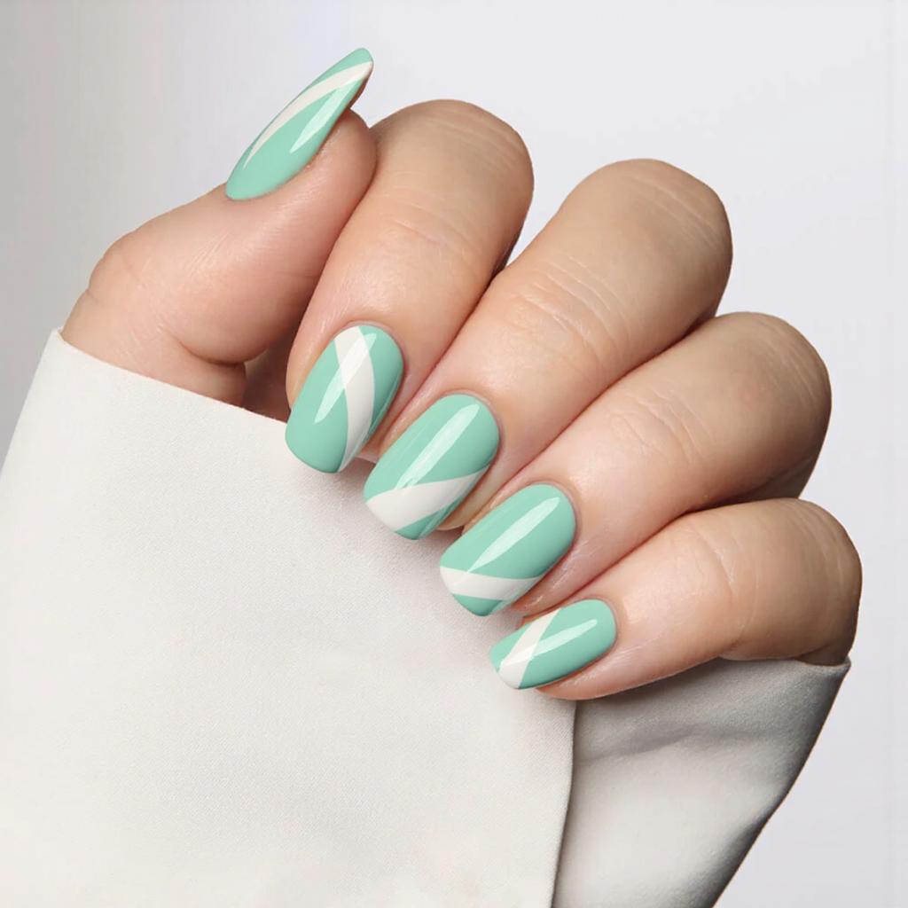 I'd love medium almond nails in a mint green hue with a subtle white swirl pattern on each nail.