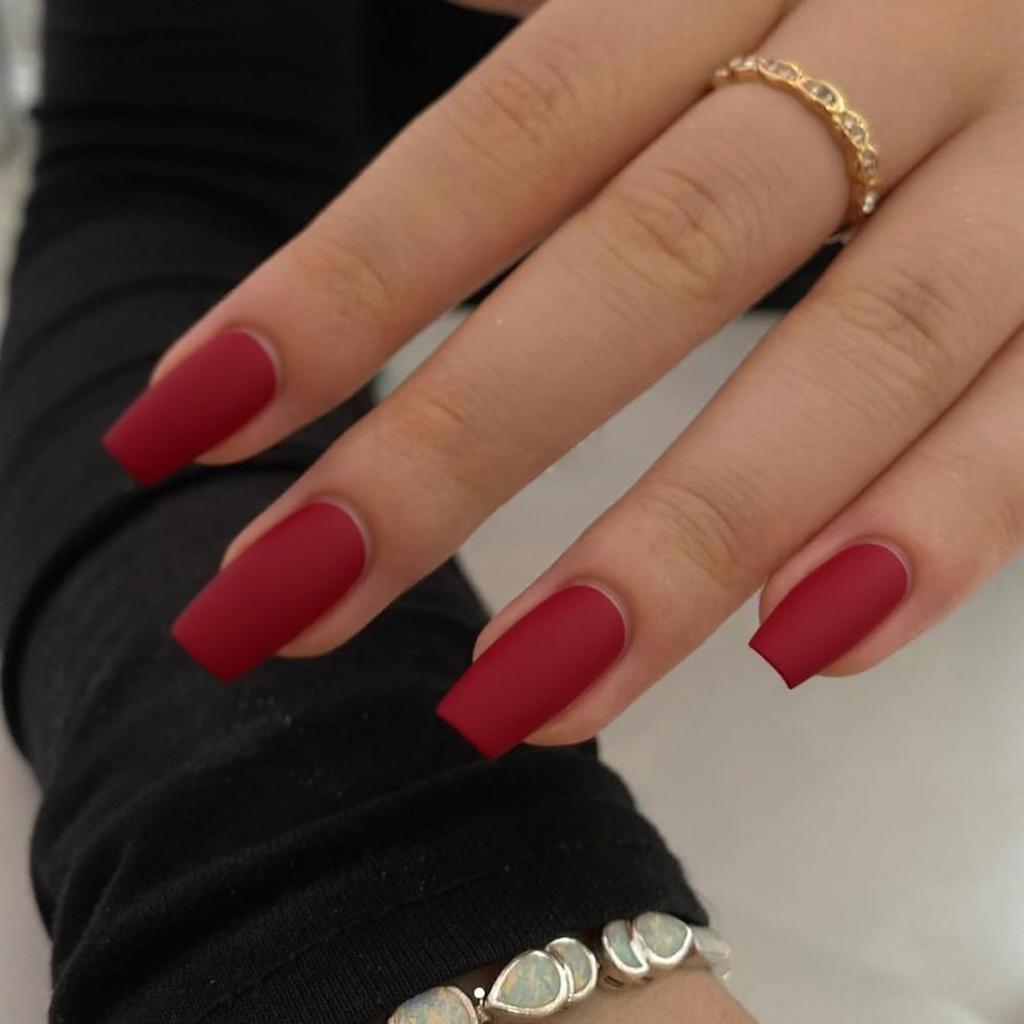 I'd like short stiletto nails in a matte red with a glossy French tip outline for subtle contrast.