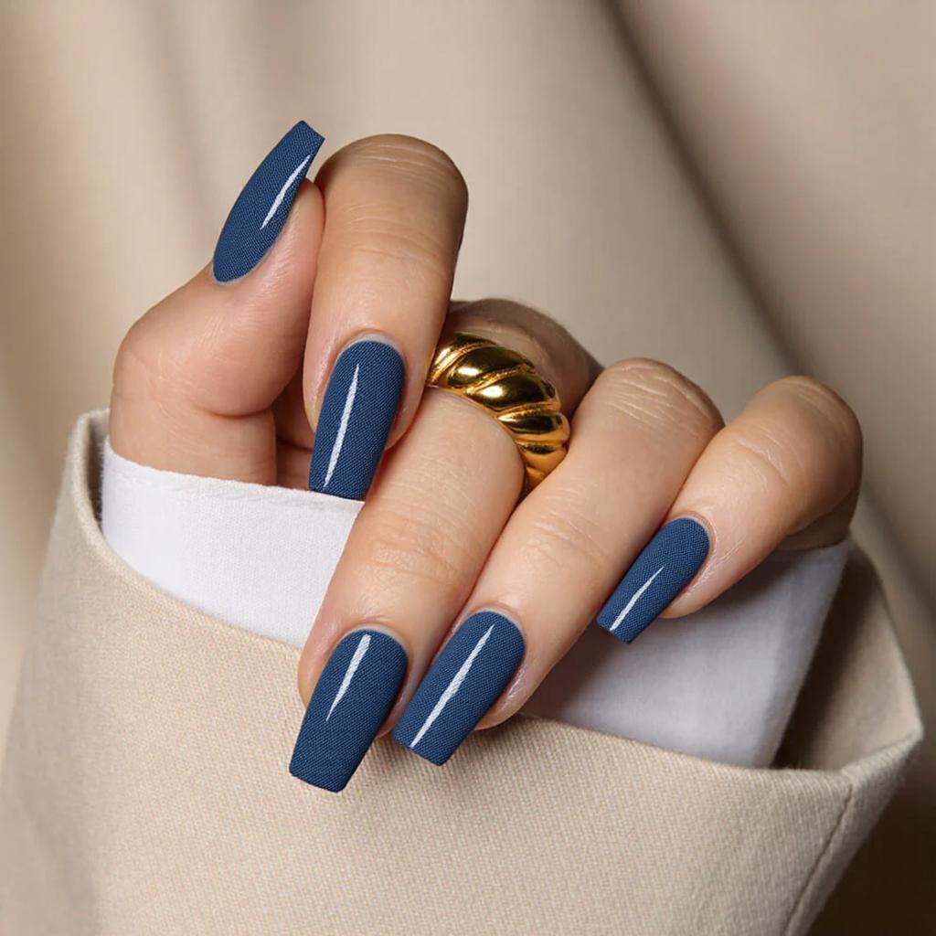 Medium square nails in a denim blue, each nail with a small white line design for a modern twist.