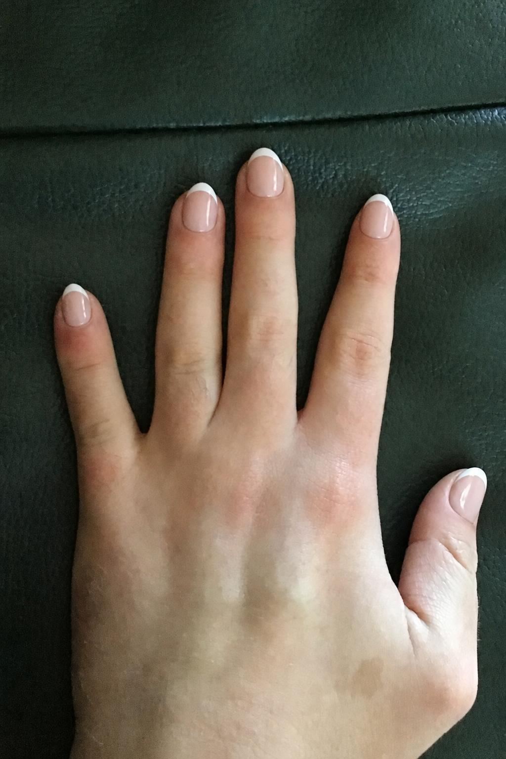 summer French Nail shape: almond. Nail length: short. Only change the nails visible in the image to match this design. Keep the rest of the image — the hand, skin, background, lighting, and everything else — exactly the same.