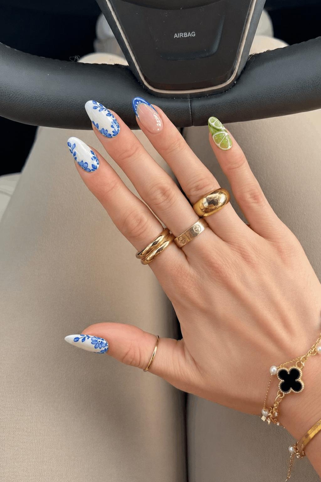 Mixed glossy set, 5 accent nails: 1–2) White base with blue floral/leaf patterns along the edges. 3) Nude base with a blue curved French outline and white dots. 4–5) 3D lime slice designs with translucent green segments and raised texture, placed across the nail surface. Nail shape: almond. Nail length: long. Only change the nails visible in the image to match this design. Keep the rest of the image — the hand, skin, background, lighting, and everything else — exactly the same.