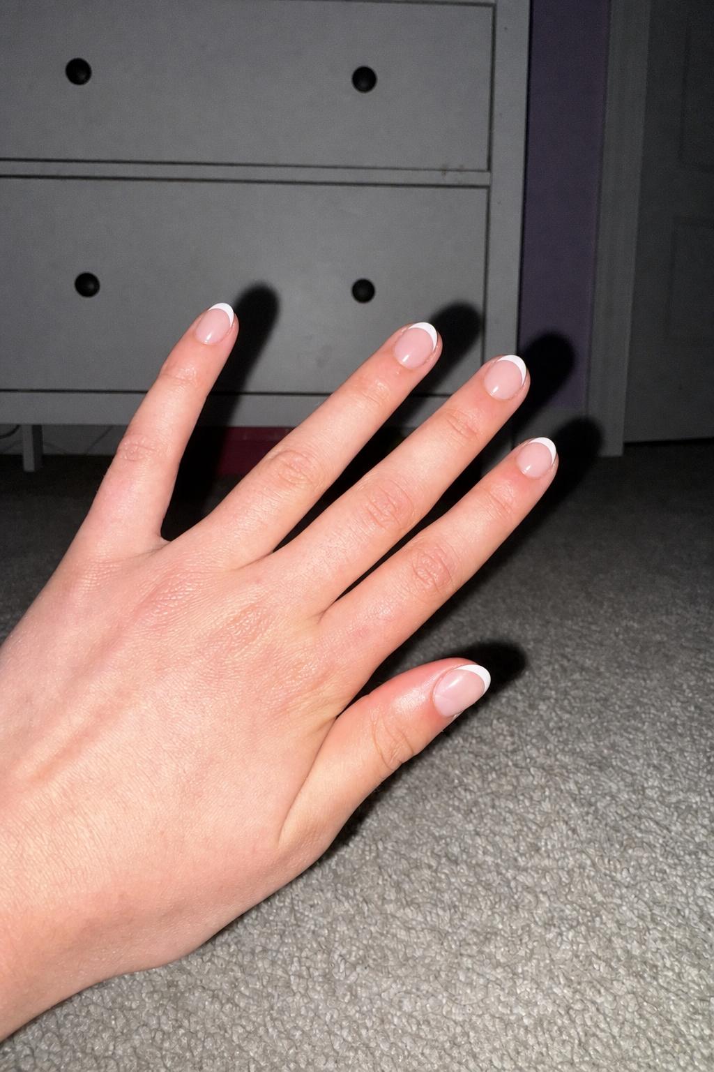 summer French Nail shape: almond. Nail length: short. Only change the nails visible in the image to match this design. Keep the rest of the image — the hand, skin, background, lighting, and everything else — exactly the same.