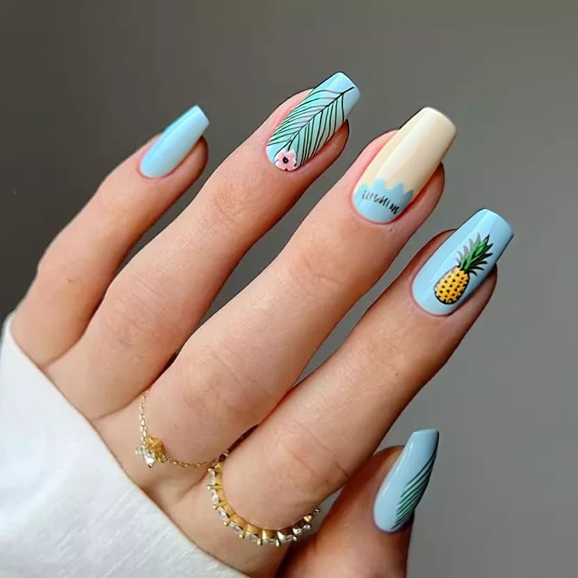 Nails adorned with a soft pastel blue base that evokes the gentle waves of a tropical beach, complemented by subtle hints of creamy ivory at the tips. On the accent nails, delicate hand-painted palm leaves in muted green gracefully arc across the surface, and tiny, minimalist hibiscus flowers in light pink bloom alongside them. The ring finger features a charming, simplified pineapple illustration, keeping the design light and whimsical without overwhelming the space. The remaining nails maintain the same pastel base, allowing the accent design to shine. A glossy finish adds a refreshing sheen, perfectly capturing the essence of a fun beach vacation while balancing elegance with playful charm on medium stiletto nails.