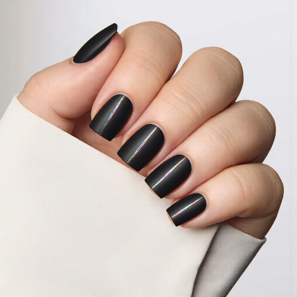 Short square nails in a matte black base with iridescent foil stripes, offering a modern and edgy 2025 design.