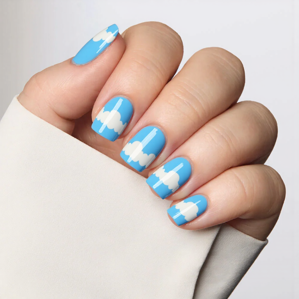 I'm looking for a short sky-blue mani with fluffy white clouds painted on one or two accent nails.