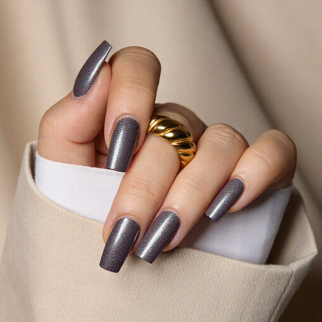 Medium square nails in a shimmering holographic finish with subtle geometric cutouts for a futuristic 2025 design.