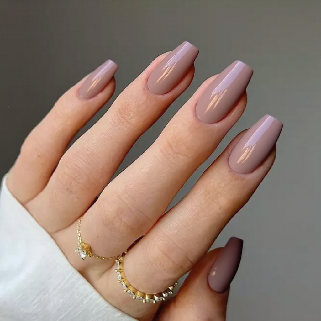 Medium stiletto nails in a dusty rose, nothing fancy—just a solid color for a quick manicure.