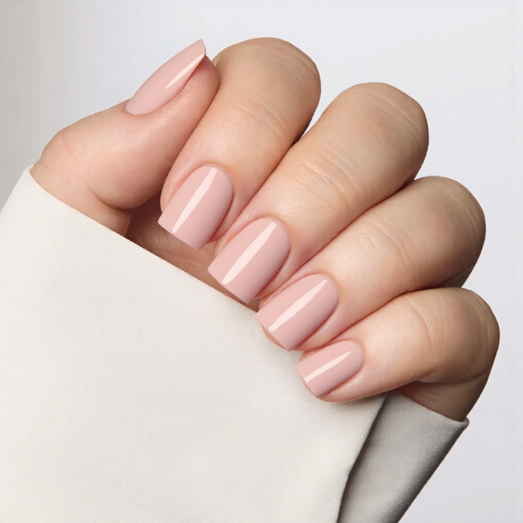 Short square nails in a sheer pink, giving them a healthy, natural look.