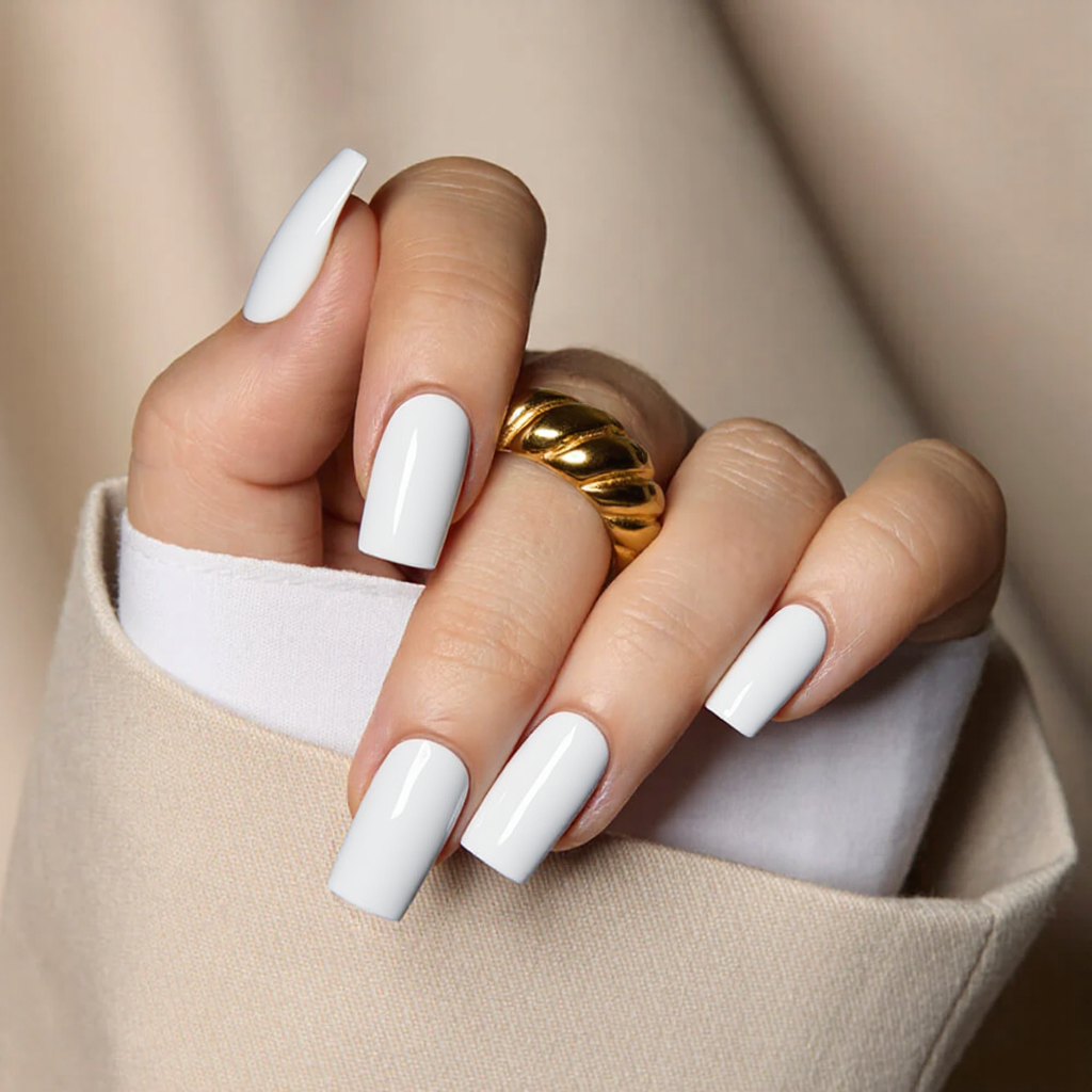 Medium square nails all in white, with a subtle glossy topcoat for a clean, chic look.