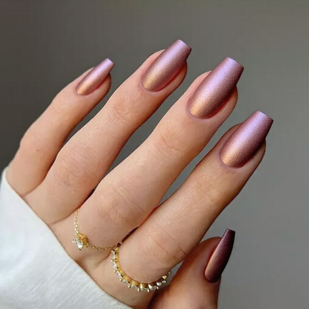 Medium stiletto nails in metallic rose-pink, perfect for a subtle yet glam statement.