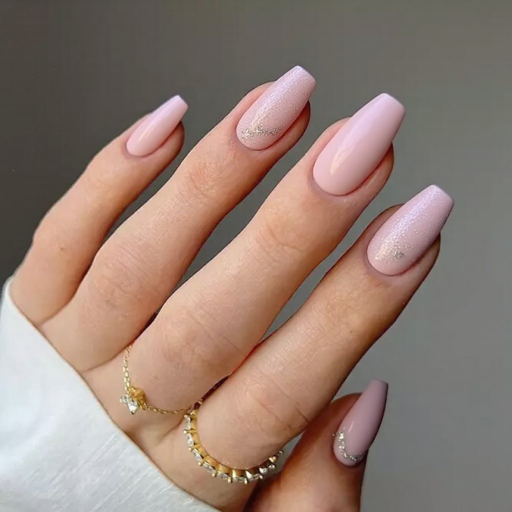 Medium stiletto nails in a cotton-candy pink with a little glitter on each tip to keep it fun.