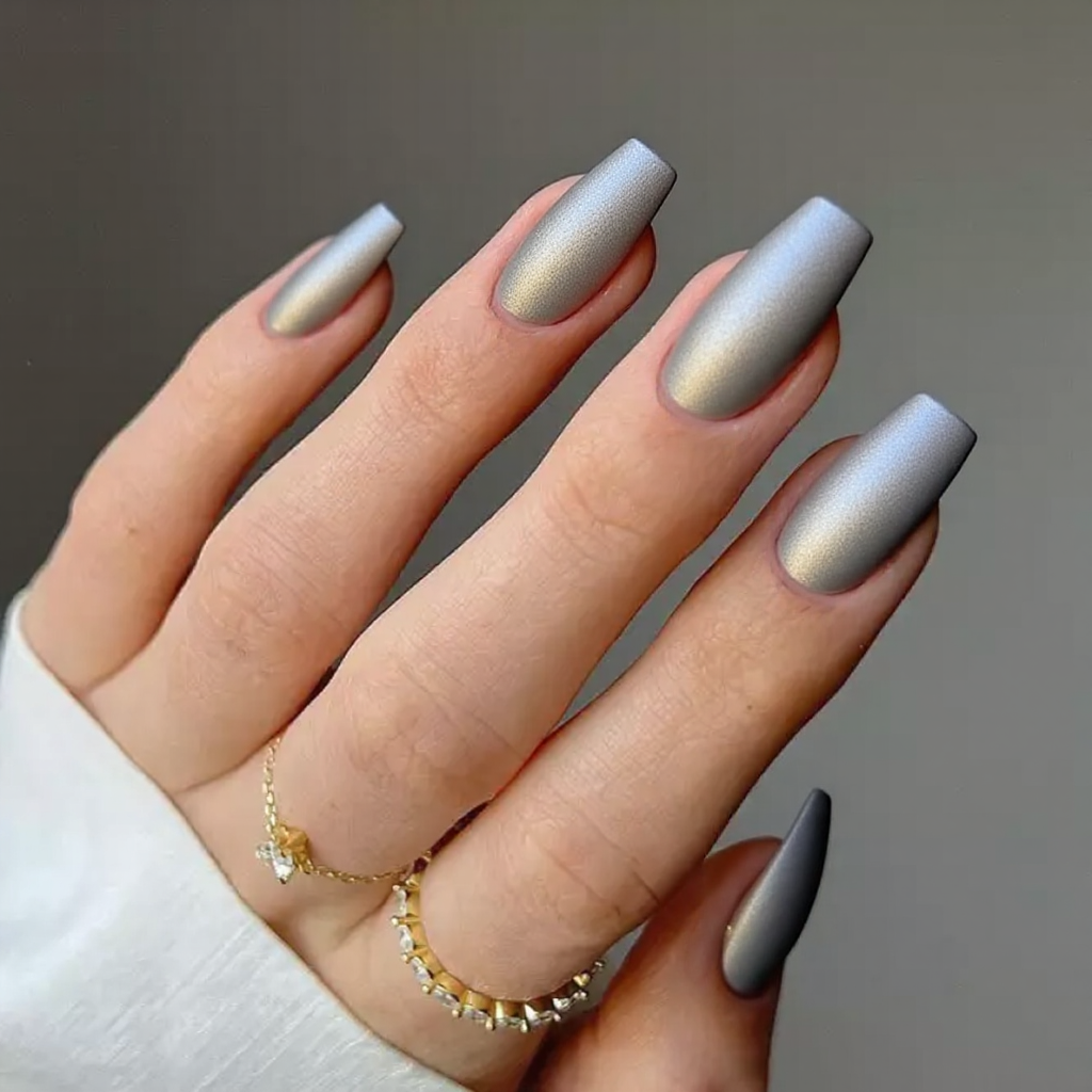 Medium stiletto nails with a matte finish and metallic chrome accents, perfect for a sleek 2025 manicure.