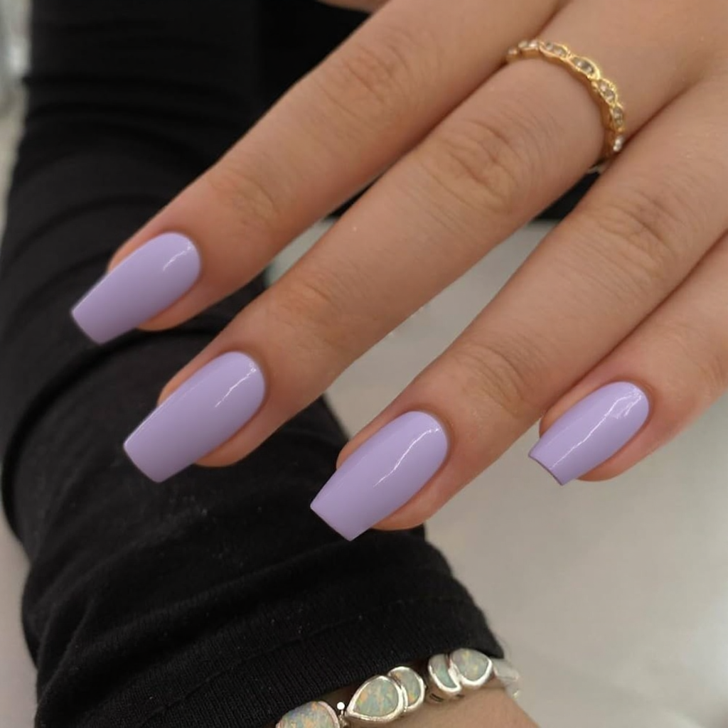 Short stiletto nails in a soft lavender with a glossy finish, offering a unique and gentle February look.