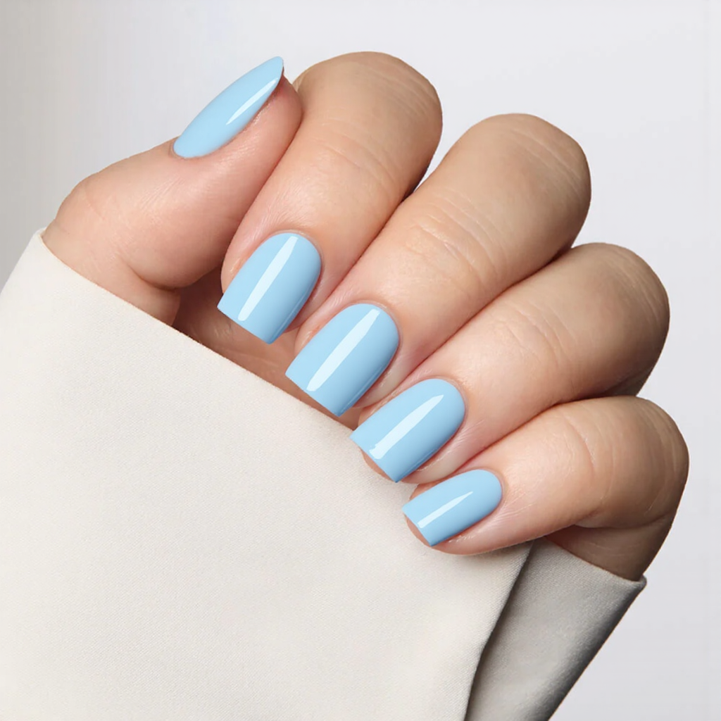 Short square nails in a baby blue shade, a one-and-done approach with no added details.