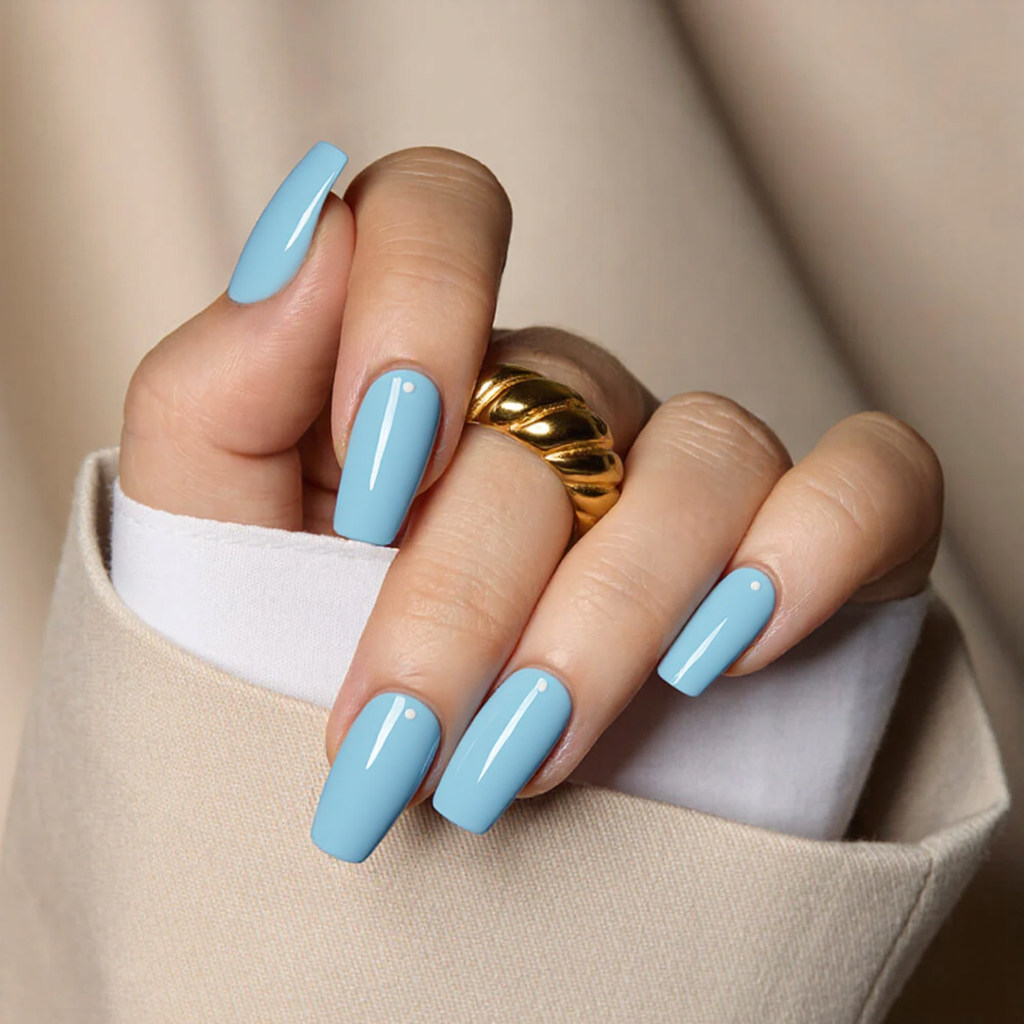 Medium square nails in baby blue with a tiny white dot near the cuticle on each nail for subtle detail.