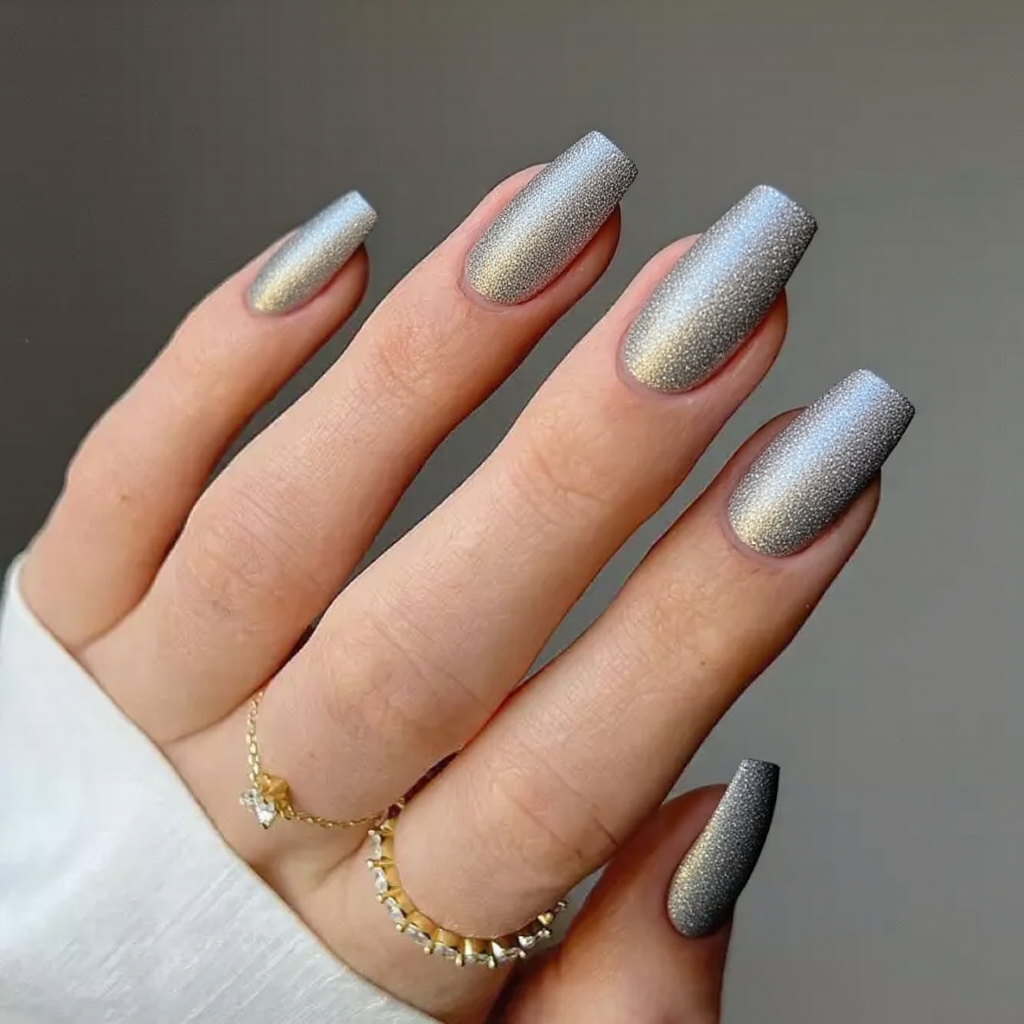 Medium stiletto nails in a metallic silver with a subtle glitter gradient for an elegant January style.