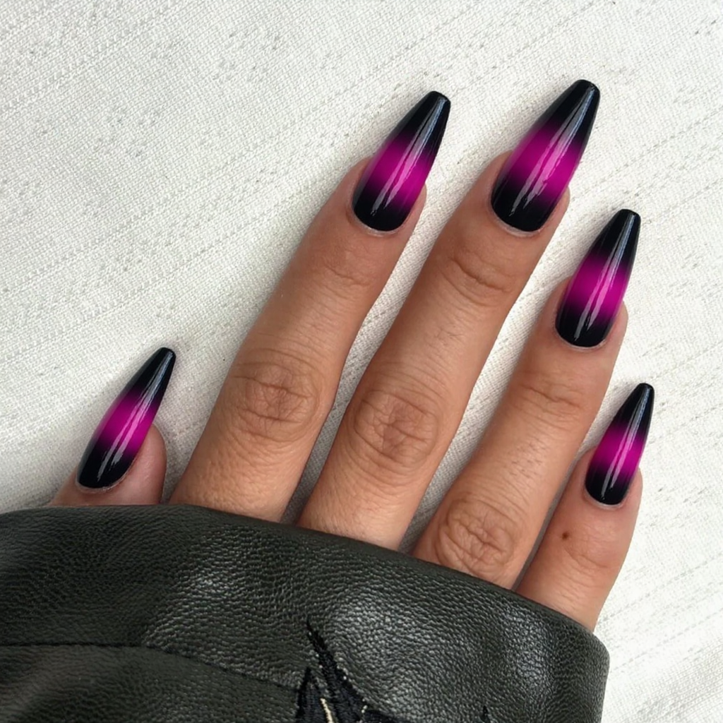 Long stiletto nails in a gradient from black at the base to bright magenta at the tips.