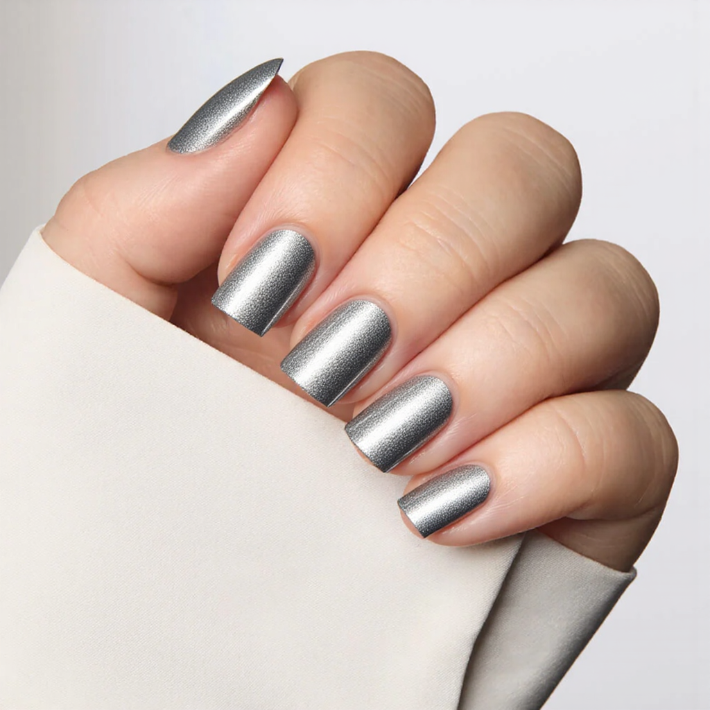 Short square nails in a V-shaped French tip, using metallic silver for an edgy twist.