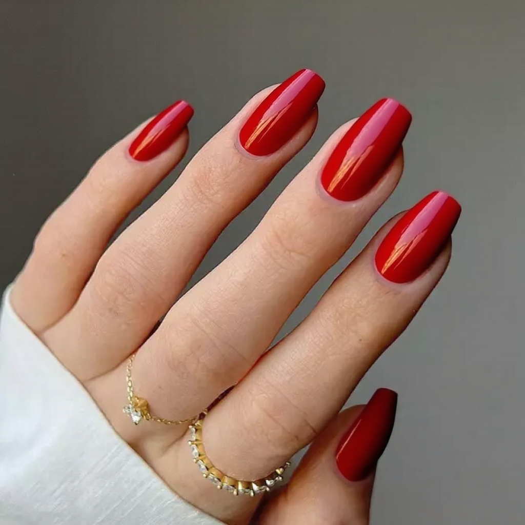 Medium stiletto nails in a glossy red, perfect for a bold everyday statement.