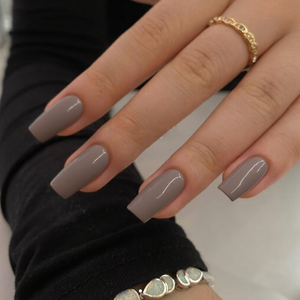 Short stiletto nails in a neutral taupe shade, glossy finish to keep it classy.