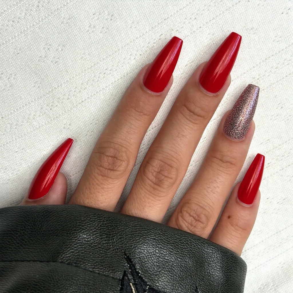 Long stiletto nails in a classic red, plus a glitter topcoat on the ring finger for a bit of sparkle.