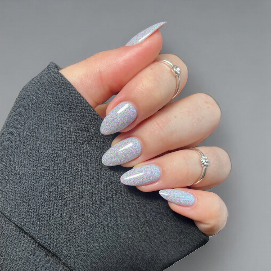 Short almond nails with a simple holographic overlay, perfect for an easy yet futuristic 2025 manicure.