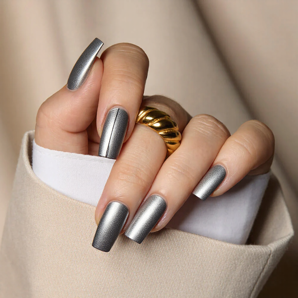 Medium square nails in a metallic silver, each with a thin black line near the tip for a modern edge.